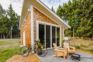 a bike parked on a patio in front of a house at Tiny house & Sauna on Lakefront Farm Oasis in Merville
