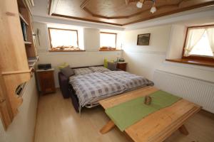 a small bedroom with a bed and a table at Kasimir Hof in Seebach