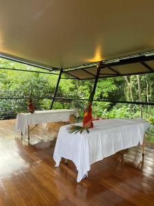 two tables in a tent with trees in the background at Hotel Arenal Glamping in Fortuna