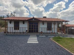 a small white house with a red roof at Villa Claudia in Villa de Leyva