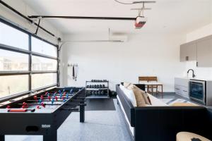 a living room with a foosball table in the middle at Sundown Scottsdale in Scottsdale