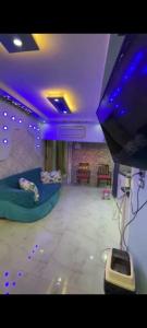 a room with purple lights and a room with beds at Sea View Studio alexandria in Alexandria