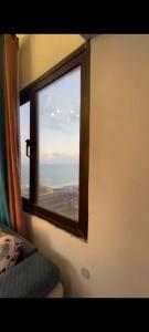 a window on a train looking out at the ocean at Sea View Studio alexandria in Alexandria
