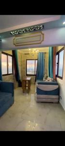 a room with a bed and a couch and a table at Sea View Studio alexandria in Alexandria