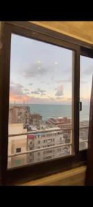 a window with a view of a city and the ocean at Sea View Studio alexandria in Alexandria