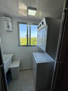 a small kitchen with a sink and a stove top oven at Hermoso apto de playa, La romana. in La Romana