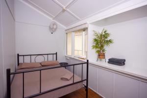 a bedroom with two bunk beds and a window at Cairns City Backpackers Hostel in Cairns