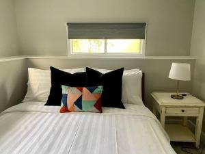 een slaapkamer met een wit bed en een raam bij Hidden Getaway, BSMT with Back Yard in Halifax
