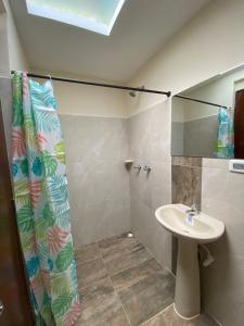 a bathroom with a sink and a shower at Hostal Don Jose in Santa Rosa de Cabal