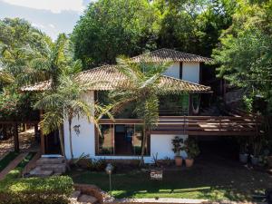 a house with a palm tree in front of it at Pousada Casa de Charme in Lençóis