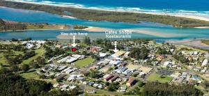 an aerial view of a suburb next to the beach at Beachside Bellingen in Urunga