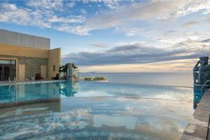 a swimming pool with a view of the ocean at M Continental by Mandala Phu Yen in Liên Trì (3)
