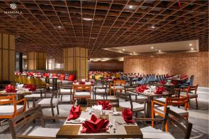 a restaurant with tables and chairs with red bows at M Continental by Mandala Phu Yen in Liên Trì (3)