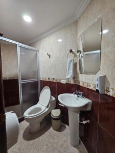 a bathroom with a toilet and a sink and a shower at HOTEL MONTERREY in Ruiosucio +99 photos