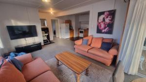 a living room with two couches and a coffee table at 44 Scarborough Tce in Hanmer Springs