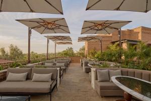 a row of chairs and umbrellas on a patio at Todos Santos Boutique Hotel in Todos Santos