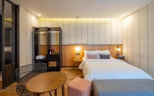 a bedroom with a large bed and a table at Hotel Barahan Jeonju in Jeonju