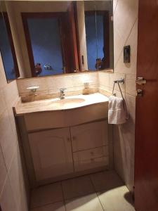 baño con lavabo y 2 espejos en Casa a 2 cuadras de la playa en Necochea