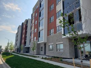 a rendering of an apartment building on a street at Luxurious Condo Apartment 2BRs-1BAs-1Office with free parking in Brampton