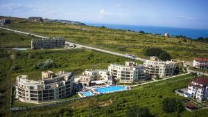 an aerial view of buildings on a hill with the ocean at Byala Panorama Resort in Byala