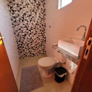 a bathroom with a white toilet and a sink at Apartamento mobilhado,5 minutos do aeroporto in Marabá