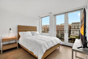 a bedroom with a bed and a large window at Hala DC in Washington, D.C.