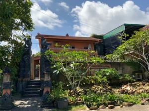 uma casa com um jardim em frente em Balinese Villa Syariah em Sekupang