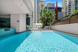 a large swimming pool on the roof of a building at 37F Brisbane CBD Apartment with City Views and Pool in Brisbane