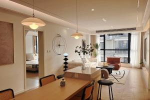 a living room with a table and a couch at Eastern Hub - Three Bedroom Apt in Xintiandi, 50m from Metro, Many Shops and Malls Surrounded in Shanghai