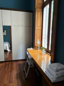 a room with a desk with a mirror and a bedroom at GABY'S HOME in Buenos Aires