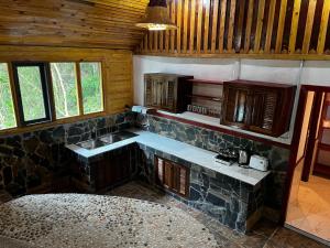 a kitchen with a stone counter and a sink at Mai Pen Rai Bungalows in Than Sadet Beach