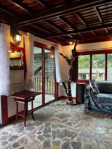 a living room with a couch and a table at Mai Pen Rai Bungalows in Than Sadet Beach