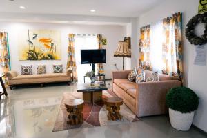 a living room with two couches and a tv at 87 Guesthouse in Baguio