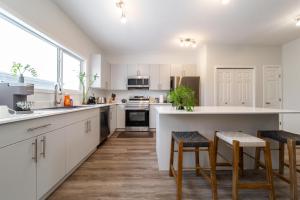 a kitchen with white cabinets and a large window at Single detached house with 3 BRM in Edmonton