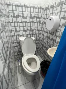 a bathroom with a toilet and a sink at POSADA DOÑA ELENA LA COMADRONA in San Juan La Laguna