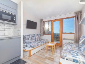 a living room with a couch and a chair at Duplex 7 pers avec WIFI, balcon à Avoriaz - FR-1-314-246 in Morzine