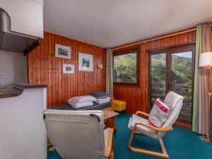 a room with a bed and two chairs in it at Appartement Avoriaz, 2 pièces, 5 personnes - FR-1-314-261 in Morzine