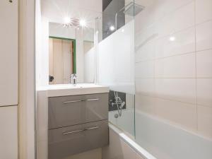 a bathroom with a sink and a mirror and a shower at Studio Avoriaz, 1 pièce, 4 personnes - FR-1-314-270 in Morzine