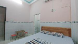 a bedroom with a bed and a table and a mirror at Ngọc Mơ Motel in Ho Chi Minh City