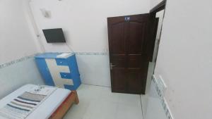 a room with a room with a door and a box at Ngọc Mơ Motel in Ho Chi Minh City