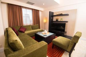 a living room with a couch and a fireplace at Perdana Kuala Lumpur City Centre in Kuala Lumpur