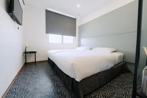 Postel nebo postele na pokoji v ubytování The Concept Hotel Melaka City