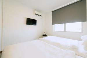Postel nebo postele na pokoji v ubytování The Concept Hotel Melaka City