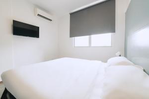 Postel nebo postele na pokoji v ubytování The Concept Hotel Melaka City