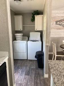 a small kitchen with a refrigerator and a microwave at Sweet retreat in the springs NOT waterfront property in Homosassa