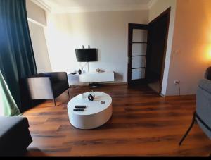 a living room with a white coffee table on a wooden floor at İstanbul Sabiha Gökçen 2 plus 1 near to Sabiha Gokcen Airport in Istanbul