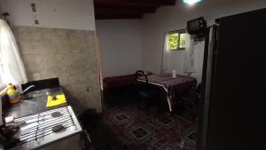 a kitchen with a stove and a table in a room at quinta el ensueño in General Rodríguez