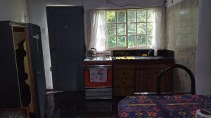 a kitchen with a stove and a sink and a window at quinta el ensueño in General Rodríguez +14 photos