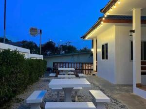a group of picnic tables outside of a building at Irada Resort Smaesarn in Ban Samae San