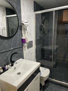 a bathroom with a sink and a shower and a toilet at Terrace Boutique Otel in Serdivan